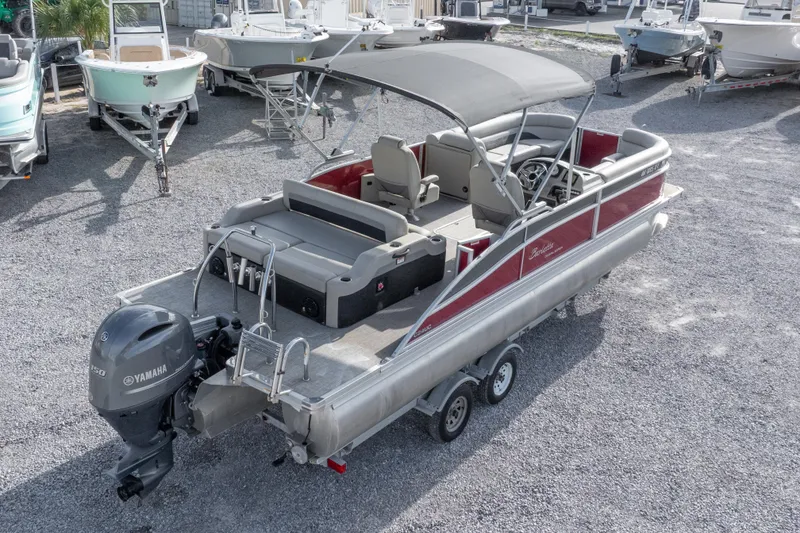 Slide: The Image of 2021 Barletta C24UC pontoon boat with Yamaha engine on trailer. - 12