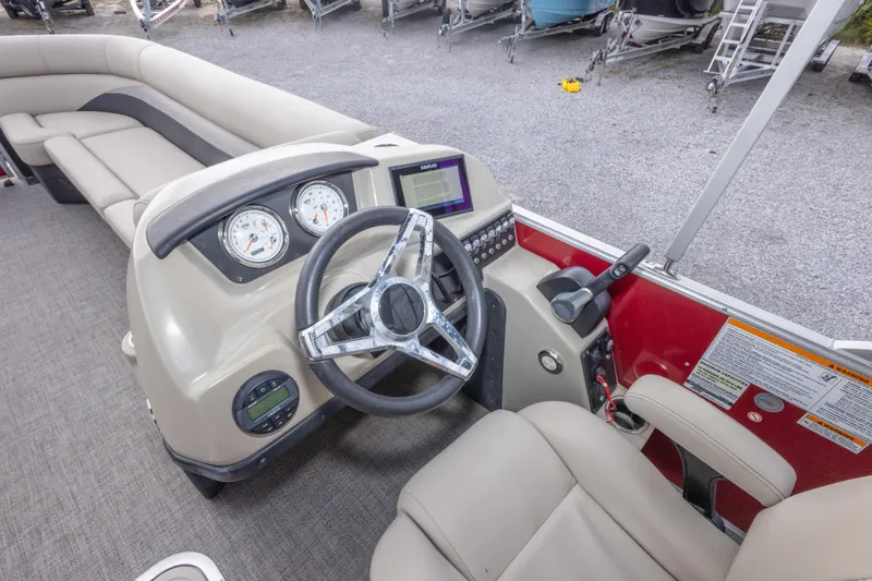 Slide: The Image of 2021 Barletta C24UC boat interior with steering wheel and control panel. - 21