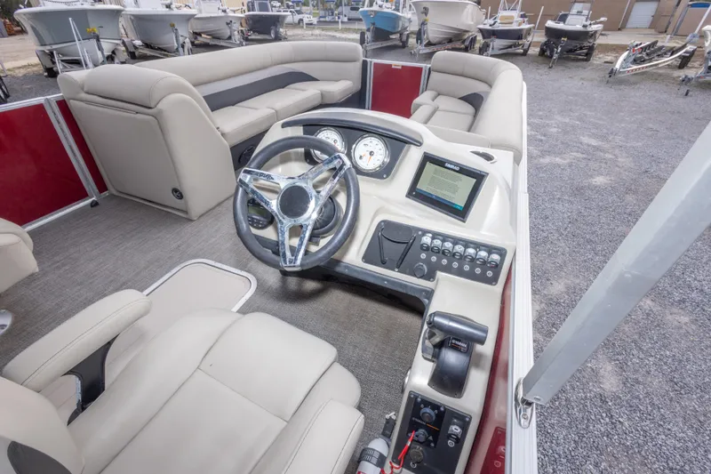 Slide: The Image of 2021 Barletta C24UC boat interior with steering wheel and control panel. - 22