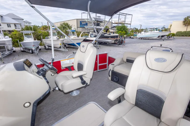Slide: The Image of 2021 Barletta C24UC pontoon boat interior with helm and seating area. - 36