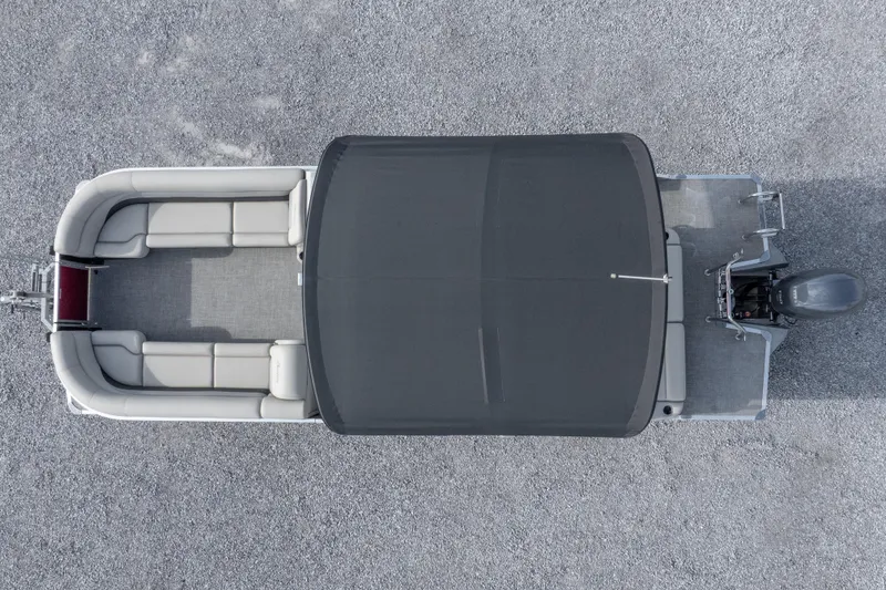 Slide: The Image of Aerial view of 2021 Barletta C24UC pontoon boat with canopy on gravel surface. - 7