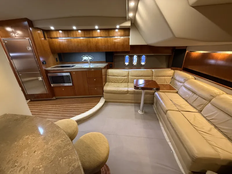 Slide: The Image of Interior of a 2008 Cruiser Yachts 420 with leather sofa and kitchenette. - 24