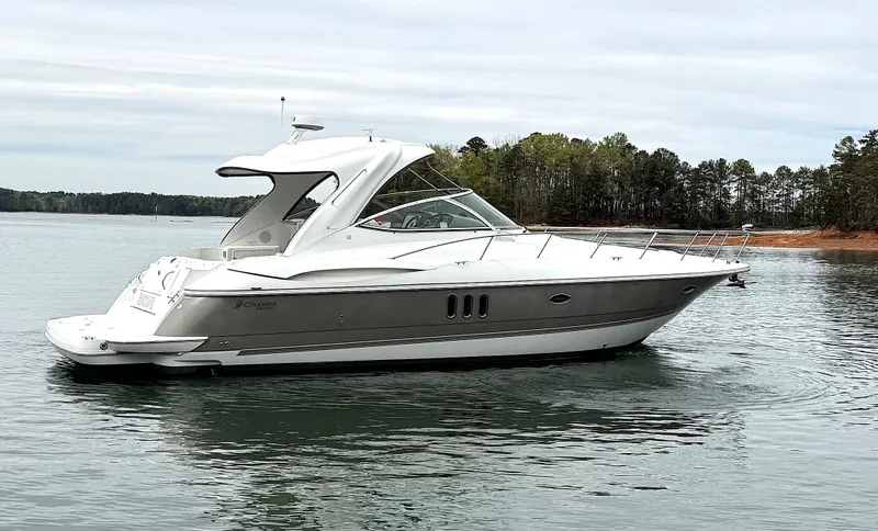 Slide: The Image of 2008 Cruiser Yachts 420 on calm water near wooded shoreline. - 8