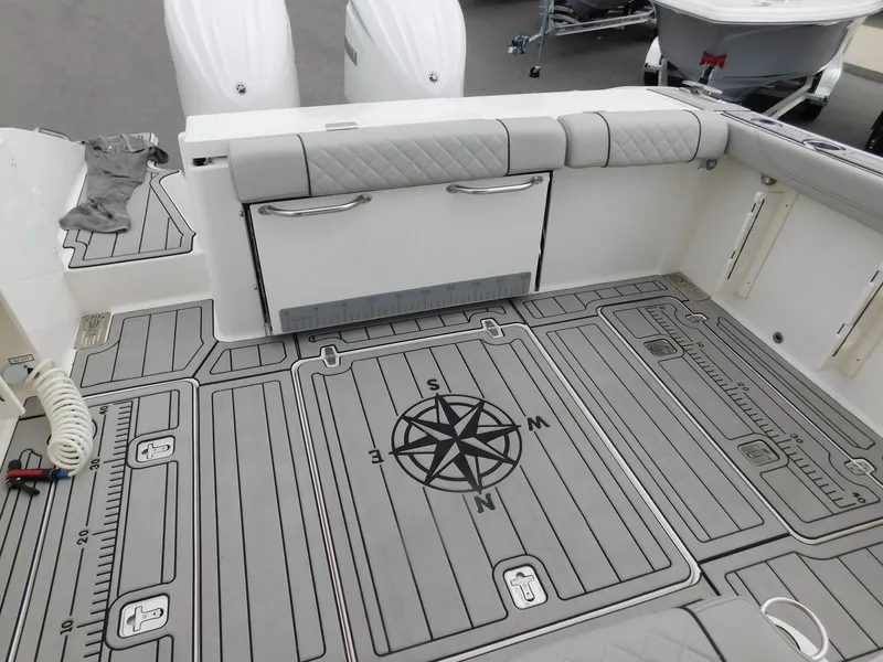 Slide: The Image of 2023 Pursuit OS 325 Offshore boat with gray deck and compass design. - 10