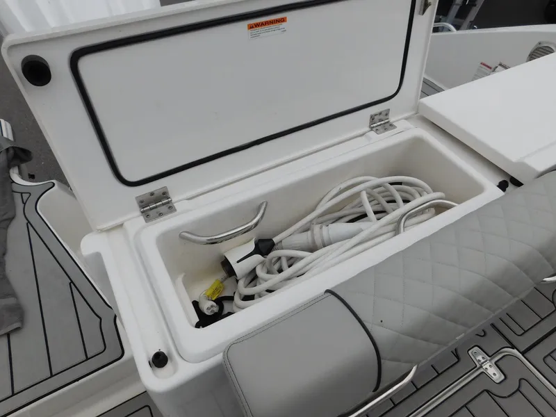 Slide: The Image of Storage compartment in Pursuit OS 325 Offshore boat with cables, 2023 model. - 12