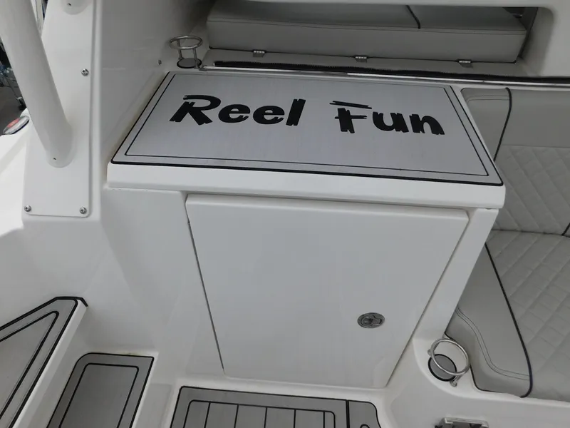 Slide: The Image of 2023 Pursuit OS 325 Offshore boat with "Reel Fun" inscription. - 14