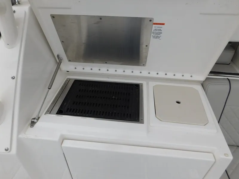 Slide: The Image of Galley area of 2023 Pursuit OS 325 Offshore with grill and sink. - 15