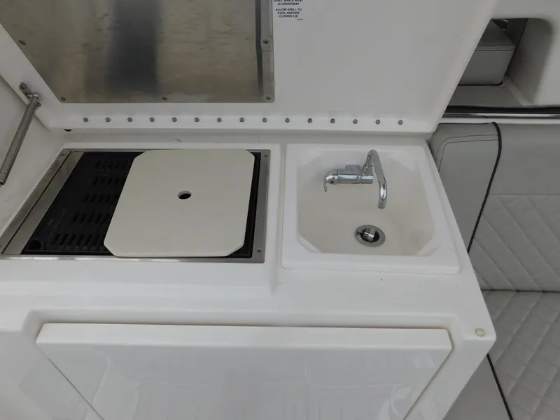 Slide: The Image of Galley on Pursuit OS 325 Offshore 2023 with sink and grill. - 16