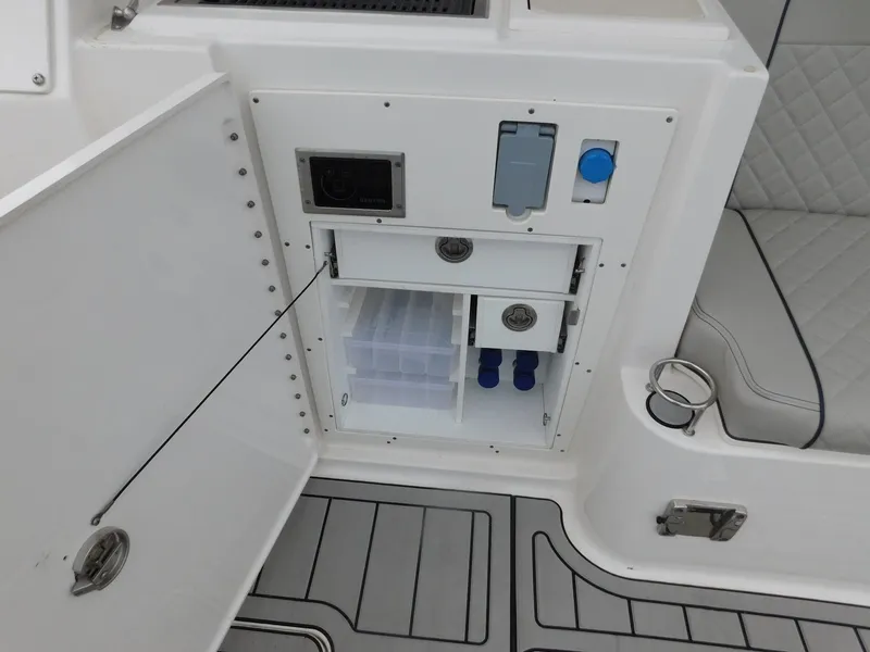 Slide: The Image of Interior view of 2023 Pursuit OS 325 Offshore with storage compartment. - 17