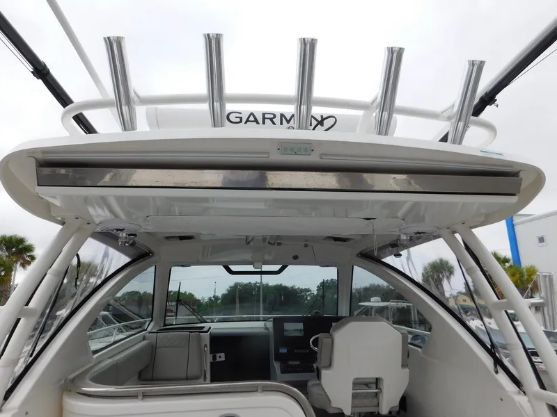 Slide: The Image of Interior view of 2023 Pursuit OS 325 Offshore with helm station. - 20