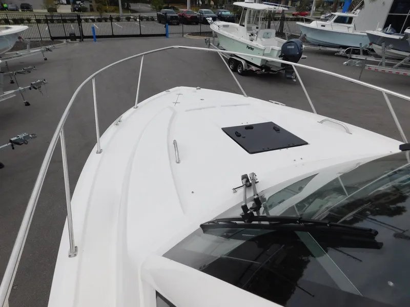 Slide: The Image of 2023 Pursuit OS 325 Offshore boat deck at a marina. - 22