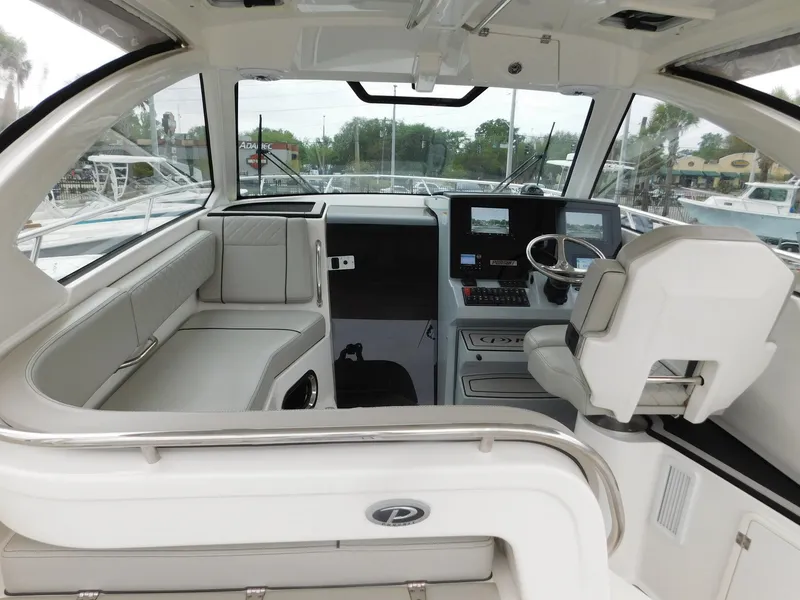 Slide: The Image of Interior of 2023 Pursuit OS 325 Offshore with helm and seating area. - 25