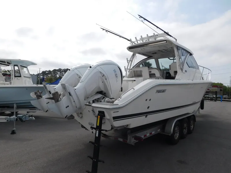 Slide: The Image of 2023 Pursuit OS 325 Offshore boat on trailer, side view. - 3