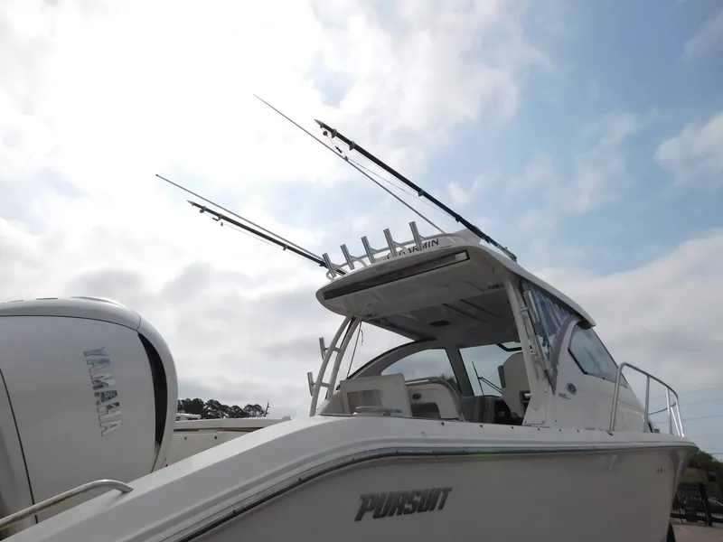 Slide: The Image of 2023 Pursuit OS 325 Offshore boat with fishing rods and Yamaha engine. - 4