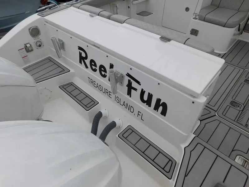 Slide: The Image of Pursuit OS 325 Offshore 2023 boat with "Reel Fun" lettering, Treasure Island, FL. - 8