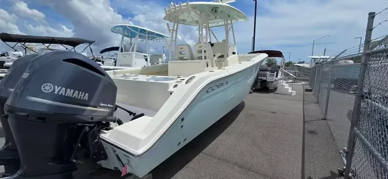 The Image of 2018 Cobia 301 Center Console boat with Yamaha engines at the dock. - 1