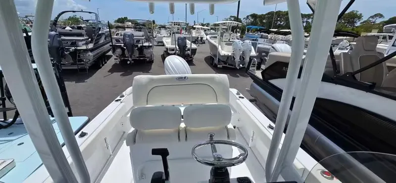 Slide: The Image of 2018 Cobia 301 Center Console boat in a parking lot. - 10