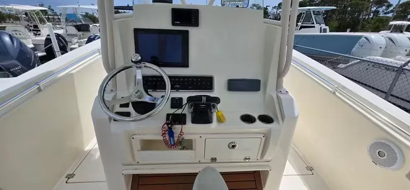 Slide: The Image of Cobia 301 Center Console 2018 helm with steering wheel and electronics. - 11