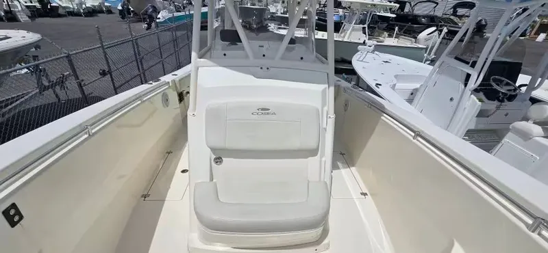 Slide: The Image of 2018 Cobia 301 Center Console boat on a marina deck. - 12