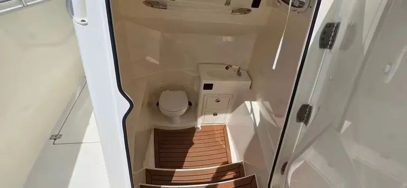 Slide: The Image of Interior of 2018 Cobia 301 Center Console with toilet and sink. - 14