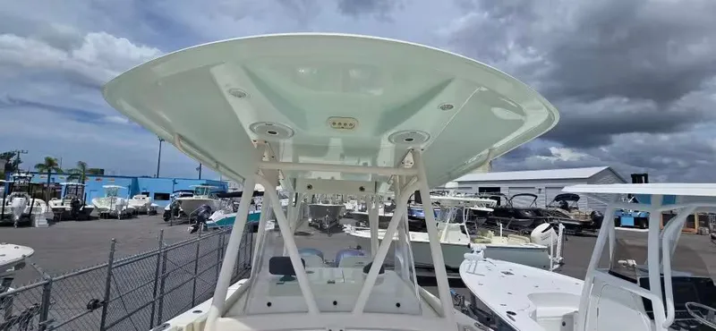 Slide: The Image of 2018 Cobia 301 Center Console boat in a parking lot. - 6