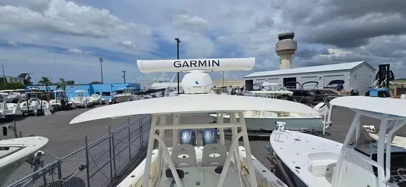 Slide: The Image of 2018 Cobia 301 Center Console boat in marina with Garmin equipment. - 7