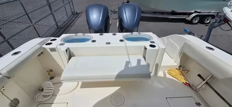 Slide: The Image of 2018 Cobia 301 Center Console with dual engines and seating area. - 8