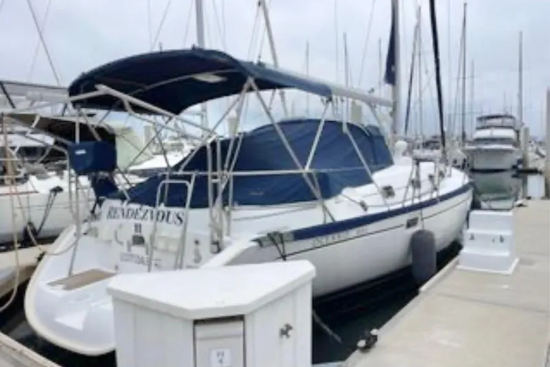 The Image of 2001 Beneteau Oceanis 461 sailboat docked at marina, featuring blue canopy and sleek design. - 0