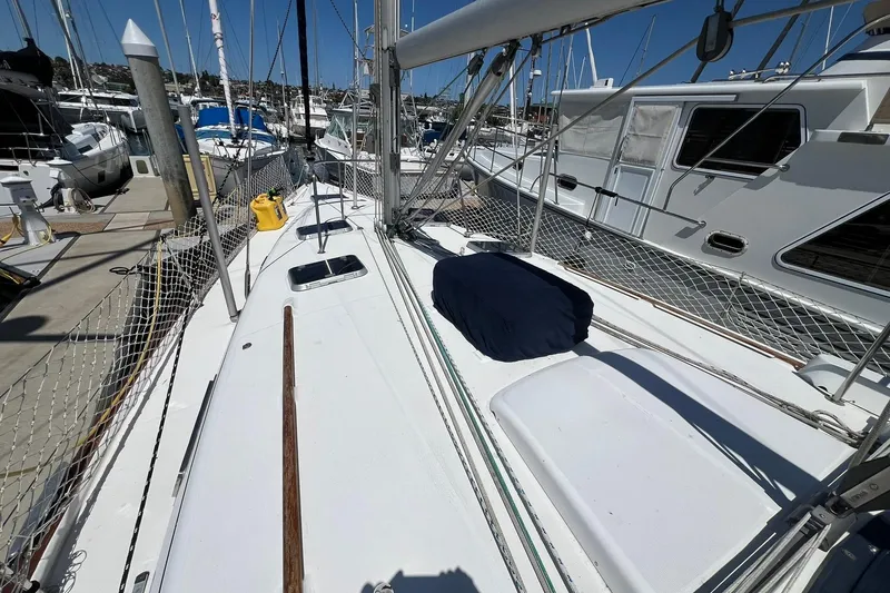 Slide: The Image of 2001 Beneteau Oceanis 461 sailboat docked at marina, showcasing deck and rigging. - 13