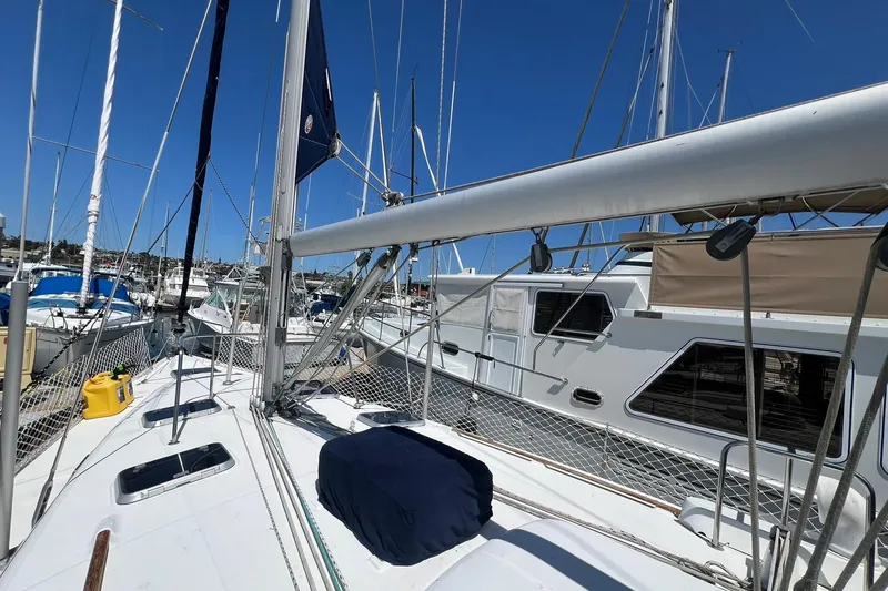 Slide: The Image of 2001 Beneteau Oceanis 461 sailboat docked in a marina under clear blue skies. - 14