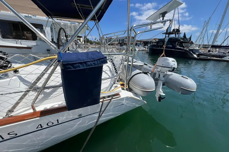 Slide: The Image of 2001 Beneteau Oceanis 461 sailboat docked with inflatable dinghy and outboard motor. - 15