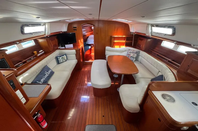 Slide: The Image of Luxurious interior of 2001 Beneteau Oceanis 461 yacht with elegant wood finish and cozy seating. - 19