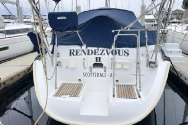 Slide: The Image of 2001 Beneteau Oceanis 461 sailboat "Rendezvous II" docked at marina, rear view. - 2