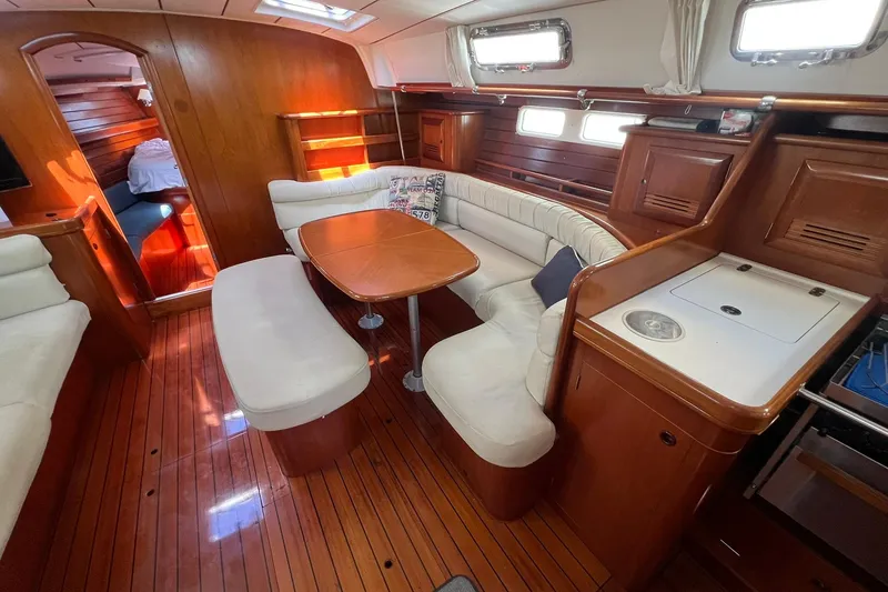 Slide: The Image of Luxurious interior of 2001 Beneteau Oceanis 461 yacht with elegant wood finish and cozy seating. - 21