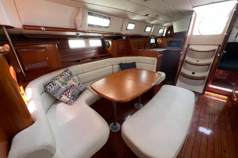 Slide: The Image of Interior of 2001 Beneteau Oceanis 461 yacht with elegant wood finish and cozy seating area. - 23