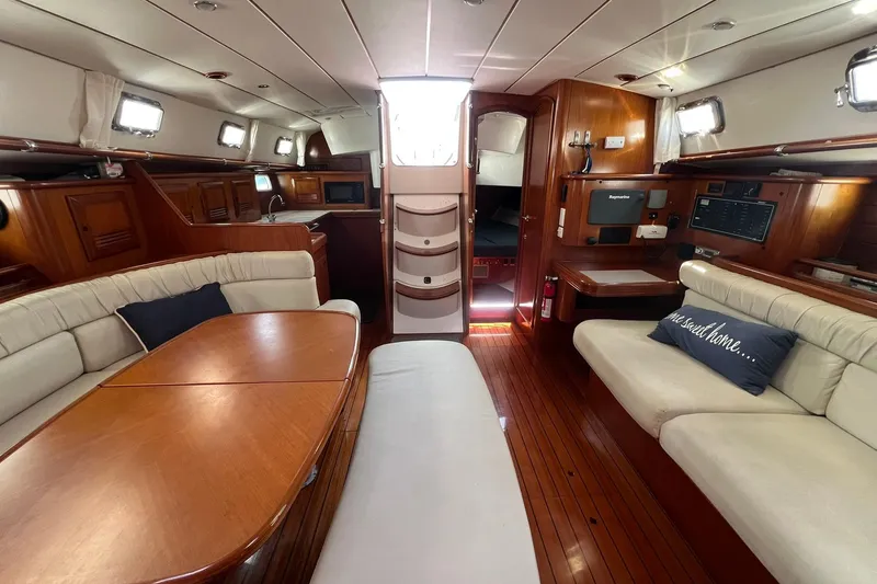 Slide: The Image of Interior of 2001 Beneteau Oceanis 461 yacht with elegant wood finish and comfortable seating. - 24