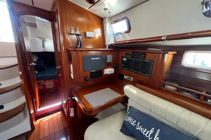 Slide: The Image of Interior of 2001 Beneteau Oceanis 461 yacht with navigation equipment and cozy seating. - 28