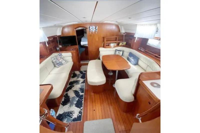 Slide: The Image of Interior of 2001 Beneteau Oceanis 461 yacht with elegant wood finish and cozy seating. - 3