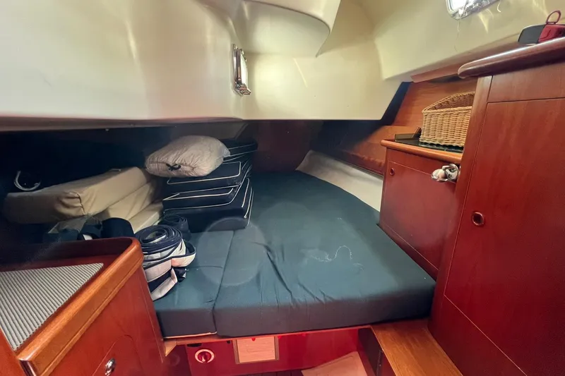 Slide: The Image of Cozy cabin interior of 2001 Beneteau Oceanis 461 sailboat with wooden cabinetry and bedding. - 30
