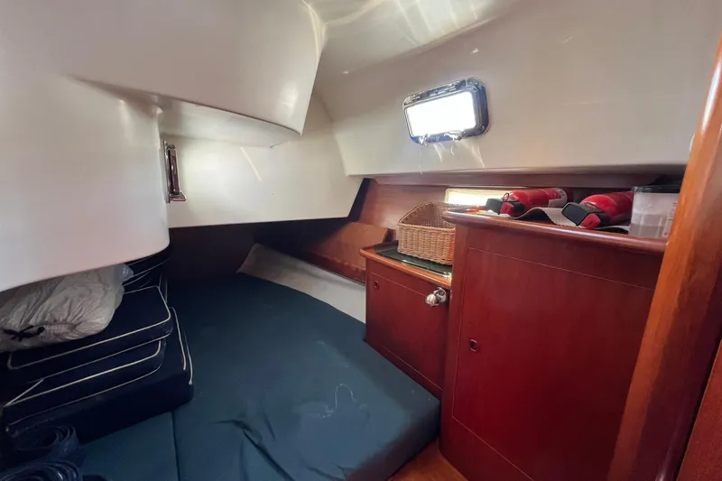 Slide: The Image of Cozy cabin interior of 2001 Beneteau Oceanis 461 sailboat with wooden cabinetry and bedding. - 31