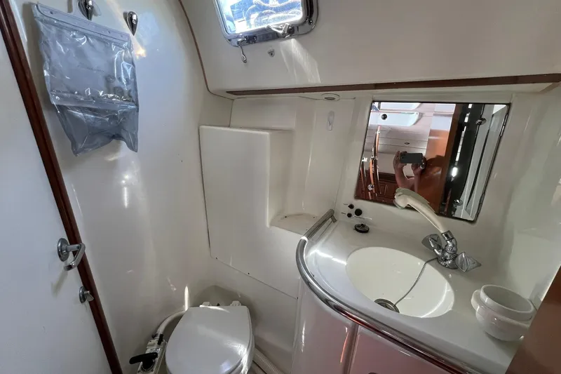Slide: The Image of Bathroom interior of 2001 Beneteau Oceanis 461 yacht, featuring sink, mirror, and toilet. - 33