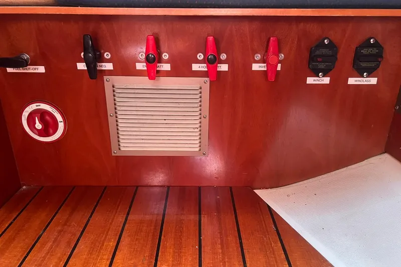 Slide: The Image of Control panel of a 2001 Beneteau Oceanis 461 sailboat with labeled switches and vent. - 35