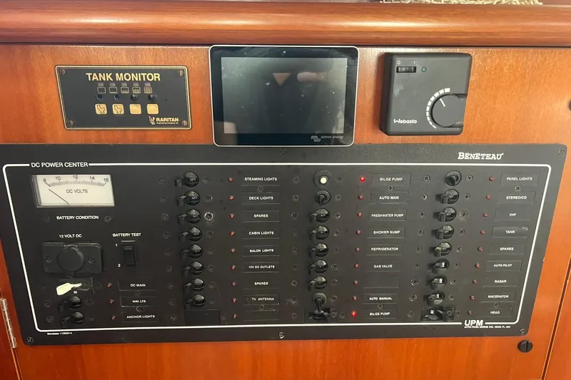 Slide: The Image of Control panel of a 2001 Beneteau Oceanis 461 yacht, featuring various switches and monitors. - 36