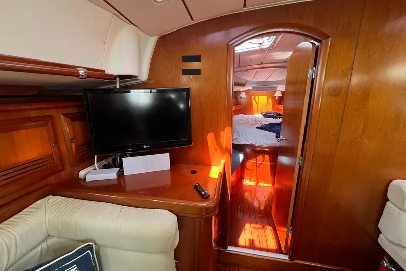 Slide: The Image of Interior of 2001 Beneteau Oceanis 461 yacht with cozy cabin and TV setup. - 37