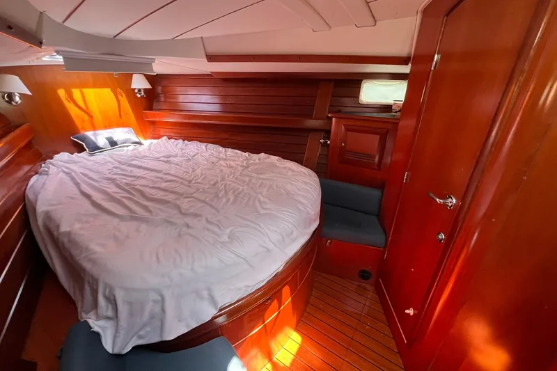 Slide: The Image of Luxurious cabin interior of 2001 Beneteau Oceanis 461 yacht with wooden finish and cozy bed. - 39