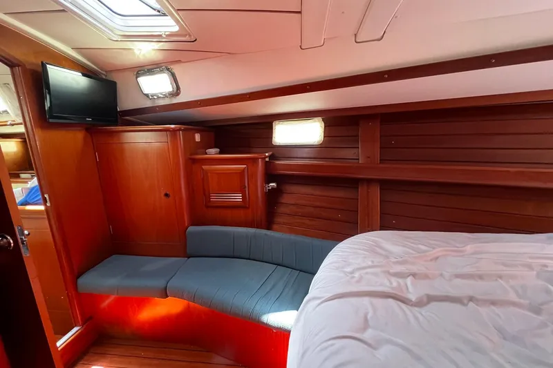 Slide: The Image of Cozy interior of 2001 Beneteau Oceanis 461 yacht with wood paneling and seating area. - 40