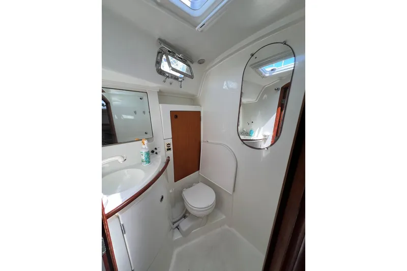 Slide: The Image of Bathroom interior of 2001 Beneteau Oceanis 461 yacht, featuring sink, toilet, and mirror. - 41
