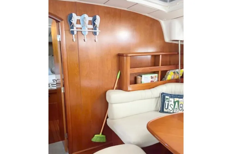 Slide: The Image of Interior of 2001 Beneteau Oceanis 461 yacht with wooden paneling and cozy seating area. - 5