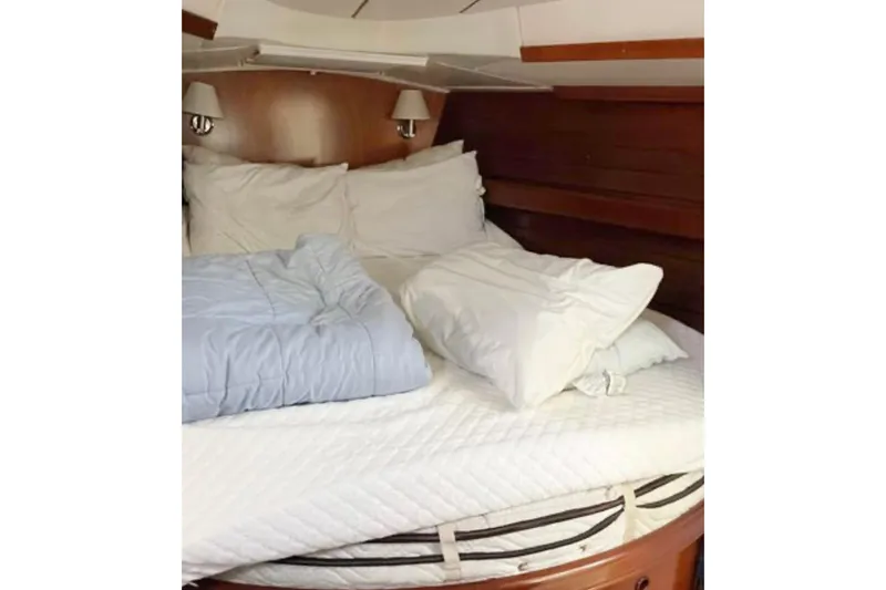 Slide: The Image of Cozy cabin bed in 2001 Beneteau Oceanis 461 yacht with pillows and bedding. - 7