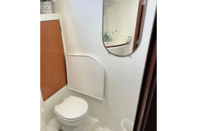 Slide: The Image of Bathroom interior of 2001 Beneteau Oceanis 461 yacht, featuring a toilet and mirror. - 8
